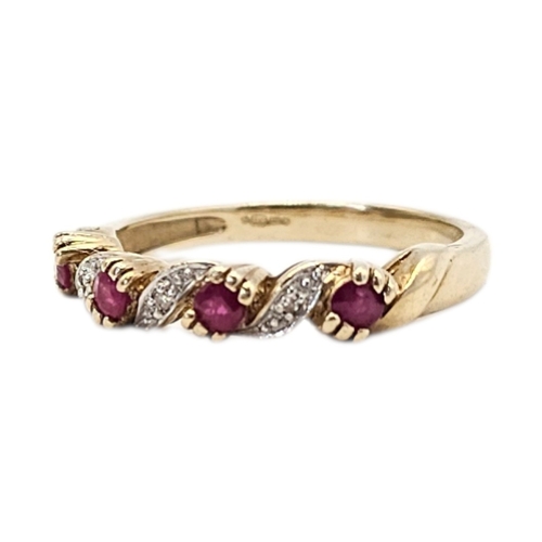 157 - A VINTAGE 9CT GOLD, RUBY AND DIAMOND HALF TWIST RING
Having a row of round cut rubies interspersed w... 