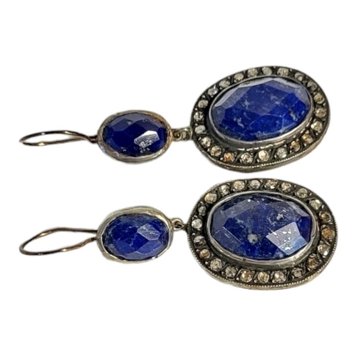 195 - A PAIR OF WHITE METAL DIAMOND AND LAPIS LAZULI EARRINGS 
Having a cabochon cut lapis stone edged wit... 