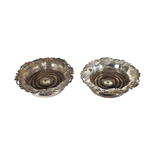 20A - A PAIR OF EARLY 20TH CENTURY SILVER PLATED WINE COASTERS
Having a vine leaf border and mahogany base... 