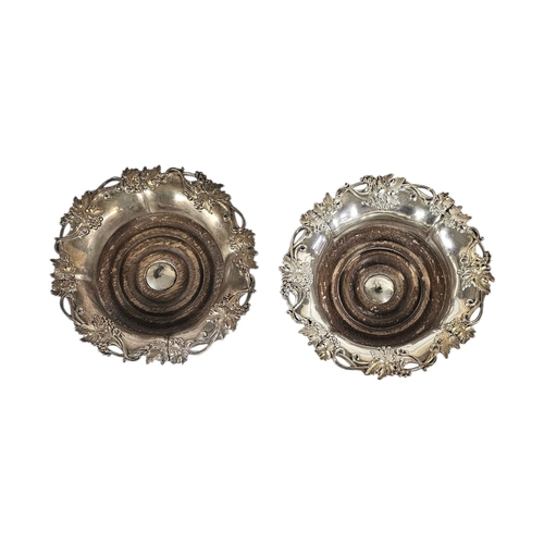 20A - A PAIR OF EARLY 20TH CENTURY SILVER PLATED WINE COASTERS
Having a vine leaf border and mahogany base... 