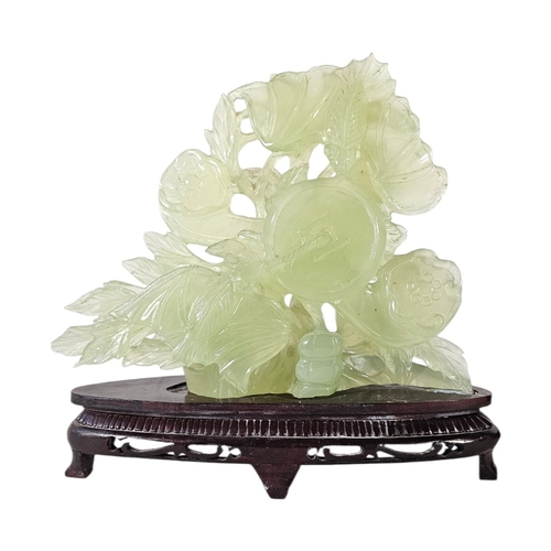 214 - A CHINESE CARVED CELADON HARDSTONE GROUP
Likely bowenite, the large scale pierced work depicting a c... 