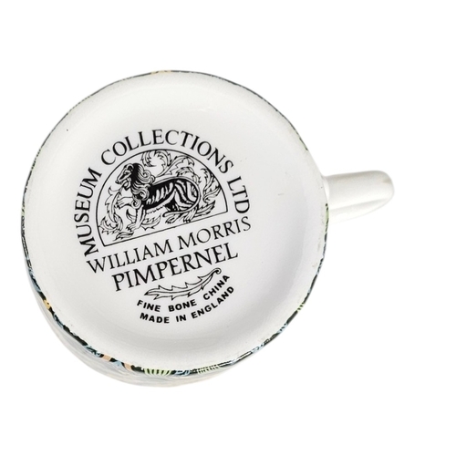 222 - A SET OF TEN WILLIAM MORRIS 'PIMPERNEL' DESIGN PORCELAIN COFFEE CANS
A fine set of eleven bone china... 
