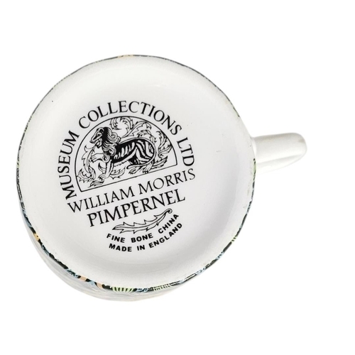 222 - A SET OF TEN WILLIAM MORRIS 'PIMPERNEL' DESIGN PORCELAIN COFFEE CANS
A fine set of eleven bone china... 