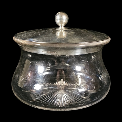 33 - A LARGE EDWARDIAN SILVER AND CUT GLASS BISCUIT BOX
Circular form with engine turned decoration and c... 