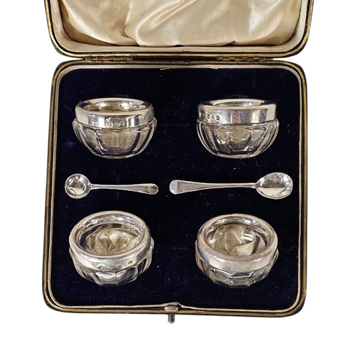 34 - A SET OF FOUR VICTORIAN SILVER AND GLASS SALTS
Each set with a silver rim hallmarked Joseph Rodgers,... 