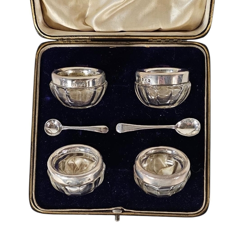 34 - A SET OF FOUR VICTORIAN SILVER AND GLASS SALTS
Each set with a silver rim hallmarked Joseph Rodgers,... 