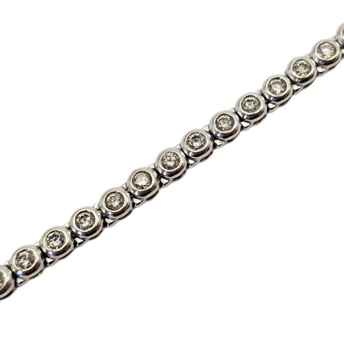 36 - A 9CT WHITE GOLD AND DIAMOND TENNIS BRACELET
Having a row of round cut diamonds.
(approx total diamo... 