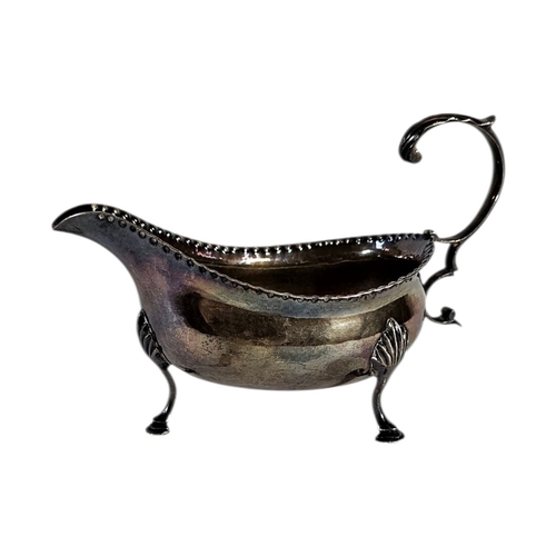 4 - A GEORGIAN SILVER SAUCE BOAT
Serrated edge with single handle, on tripod legs, hallmarked 1782.
(app... 