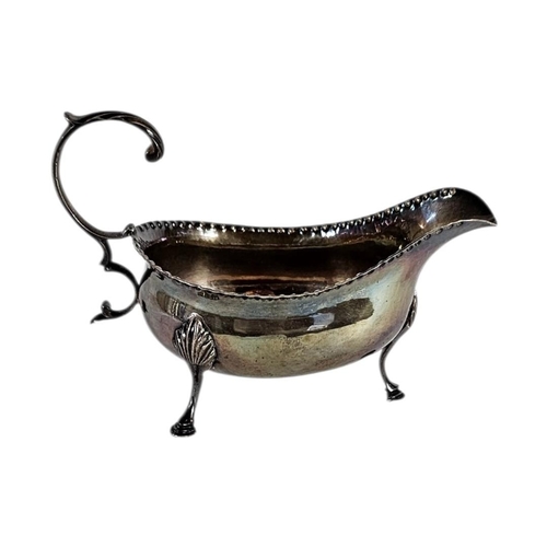 4 - A GEORGIAN SILVER SAUCE BOAT
Serrated edge with single handle, on tripod legs, hallmarked 1782.
(app... 