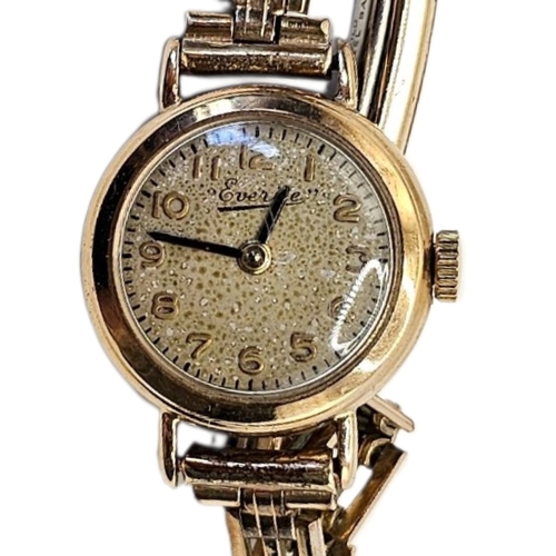 65 - EVERITE, A VINTAGE 9CT GOLD LADIES’ WRISTWATCH
Having Arabic number markings, on a rolled gold brace... 