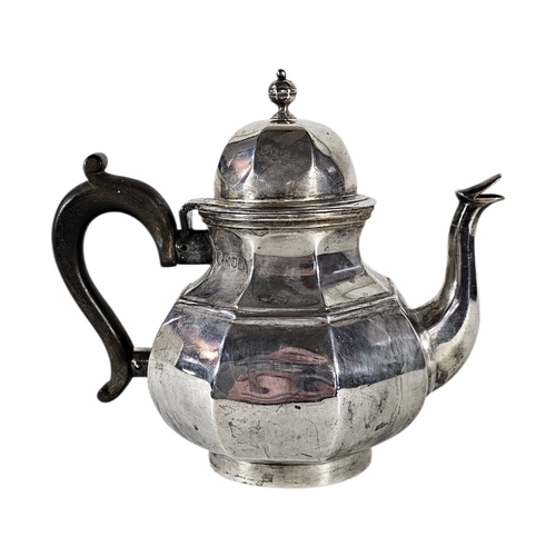 79 - AN EARLY 20TH CENTURY SILVER TEAPOT
Octagonal form, with turned wooden handle, hallmarked London, 19... 