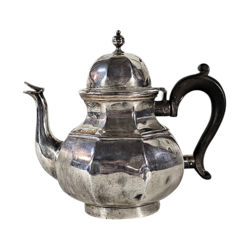 79 - AN EARLY 20TH CENTURY SILVER TEAPOT
Octagonal form, with turned wooden handle, hallmarked London, 19... 