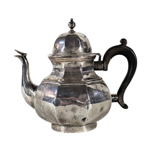 79 - AN EARLY 20TH CENTURY SILVER TEAPOT
Octagonal form, with turned wooden handle, hallmarked London, 19... 