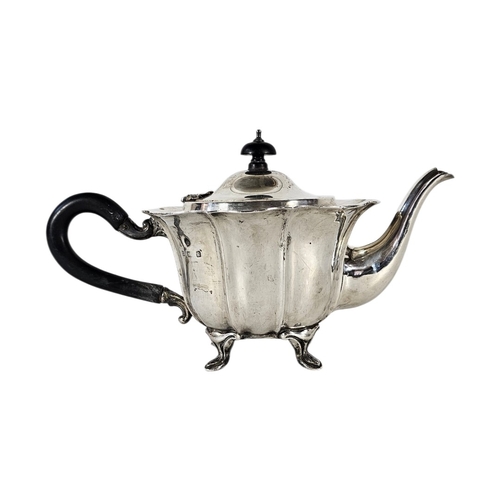 80 - AN EARLY 20TH CENTURY SILVER TEAPOT
Having a scalloped edge and ebonized handle, hallmarked.
(approx... 