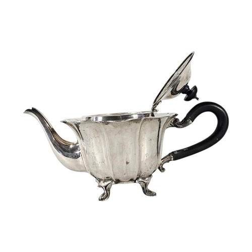 80 - AN EARLY 20TH CENTURY SILVER TEAPOT
Having a scalloped edge and ebonized handle, hallmarked.
(approx... 