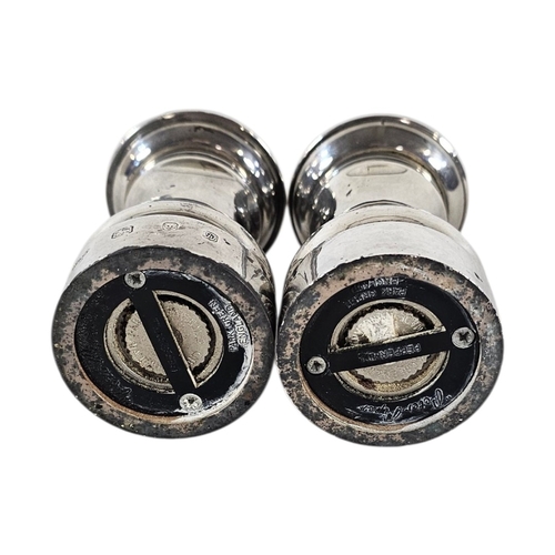 89 - A PAIR OF 20TH CENTURY SILVER PEPPER MILLS
Plain form, with reading base marked ‘Peter Piper’, hallm... 