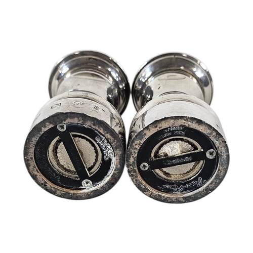 89 - A PAIR OF 20TH CENTURY SILVER PEPPER MILLS
Plain form, with reading base marked ‘Peter Piper’, hallm... 