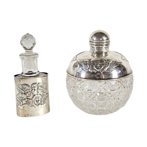 96 - TWO EARLY 20TH CENTURY SILVER AND CUT GLASS ‘REYNOLDS ANGELS’ SCENT BOTTLES
To include a larger bott... 