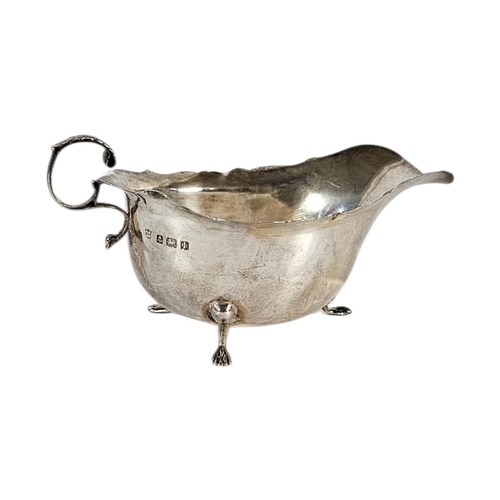 17 - AN EARLY 20TH CENTURY SILVER SAUCE BOAT
Having a single handle and scalloped edge, hallmarked Birmin... 