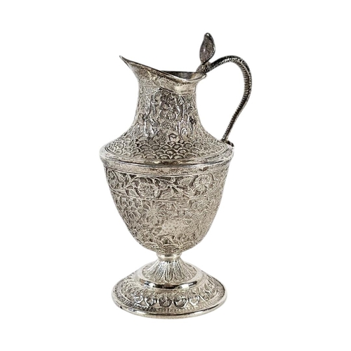 20 - AN EARLY 20TH CENTURY INDIAN SILVER CREAM JUG
Having chased decoration of animals within foliage.
(a... 