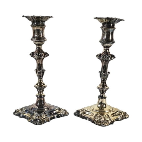 27 - A PAIR OF 19TH CENTURY GILDED WHITE METAL CANDLESTICK
An ornate pair of George II revival candlestic... 