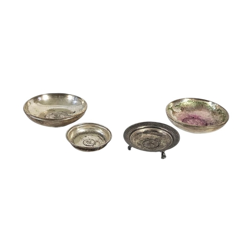 6 - A COLLECTION OF FOUR EARLY 20TH CENTURY TURKISH SILVER COIN SET DISHES
The base set with Turkish ott... 