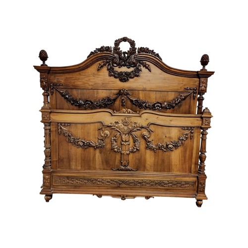 577 - A VICTORIAN MAHOGANY DOUBLE BEDSTEAD
Adorned with pineapple finials, floral wreaths and swags, compl... 