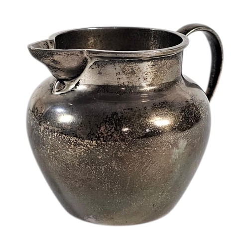 19 - AN EARLY 20TH CENTURY SILVER CREAM JUG
Plain form, hallmarked London, 1932.
(approx 7cm, approx 143.... 