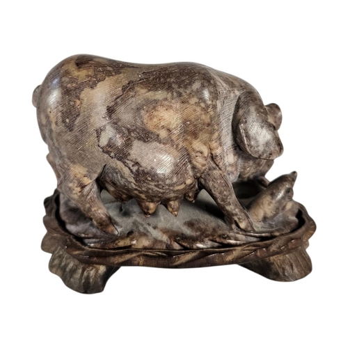 22 - AN EARLY 20TH CENTURY CHINESE CARVED SOAPSTONE GROUP OF A SOW AND PIGLETS
The mottled honey coloured... 