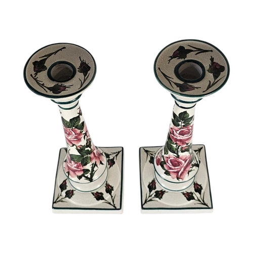 41 - WEMYSS WARE, A PAIR OF EARLY 20TH CENTURY 'CABBAGE ROSE' POTTERY CANDLESTICKS
Tall form with pink bl... 