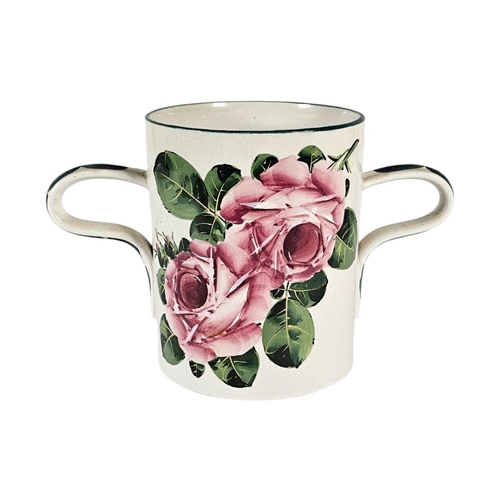 45 - A LARGE EARLY 20TH CENTURY WEMYSS ‘CABBAGE ROSE’ POTTERY LOVING CUP 
Twin handles with hand painted ... 