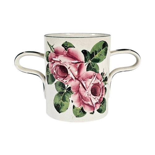 45 - A LARGE EARLY 20TH CENTURY WEMYSS ‘CABBAGE ROSE’ POTTERY LOVING CUP 
Twin handles with hand painted ... 