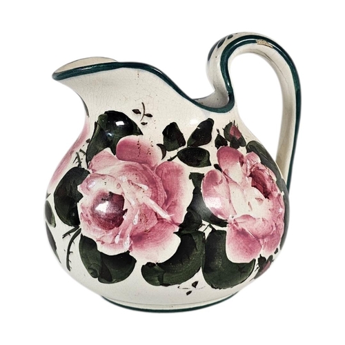 48 - AN EARLY 20TH CENTURY WEMYSS ‘CABBAGE ROSE’ POTTERY WATER JUG
Hand painted decoration of pink roses,... 