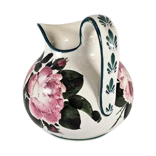 48 - AN EARLY 20TH CENTURY WEMYSS ‘CABBAGE ROSE’ POTTERY WATER JUG
Hand painted decoration of pink roses,... 