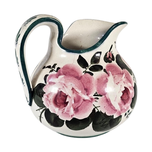 48 - AN EARLY 20TH CENTURY WEMYSS ‘CABBAGE ROSE’ POTTERY WATER JUG
Hand painted decoration of pink roses,... 