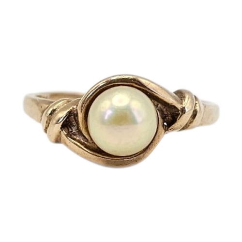 6 - A VINTAGE 9CT GOLD AND PEARL SOLITAIRE RING 
The single pearl in a rope twist design.
(size P, appro... 