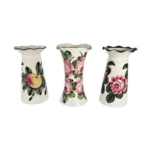 60 - WEMYSS WARE, A COLLECTION OF THREE EARLY 20TH CENTURY POTTERY VASES
Having flared rims and painted d... 