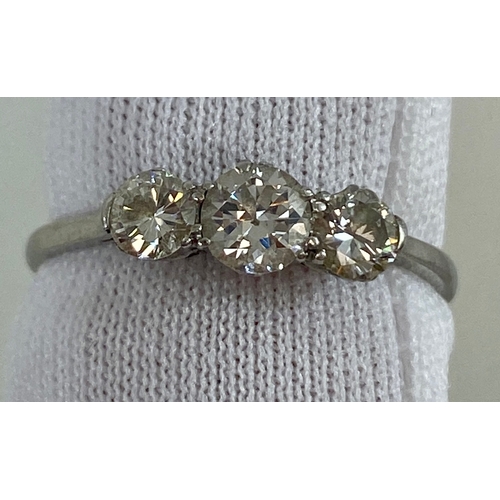 674 - Three Brilliant Cut Diamonds about 3.6 to 4.5mm Diameter set in a row of collets on a White Shank St... 