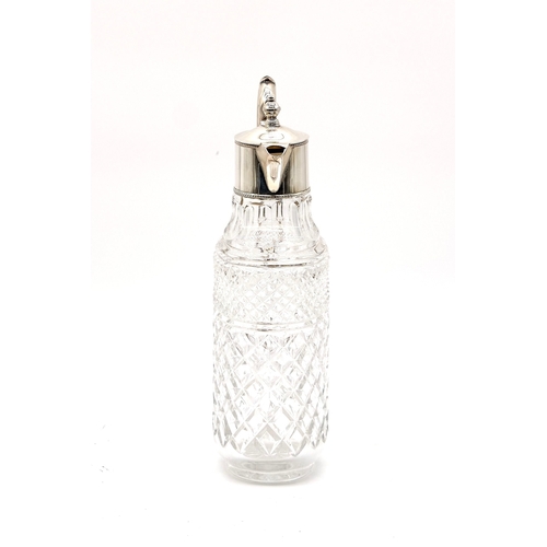 65 - Silver plated cut glass decanter with scroll handle