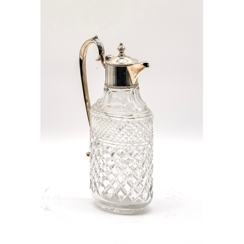 65 - Silver plated cut glass decanter with scroll handle