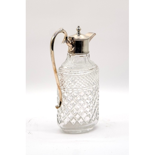 65 - Silver plated cut glass decanter with scroll handle