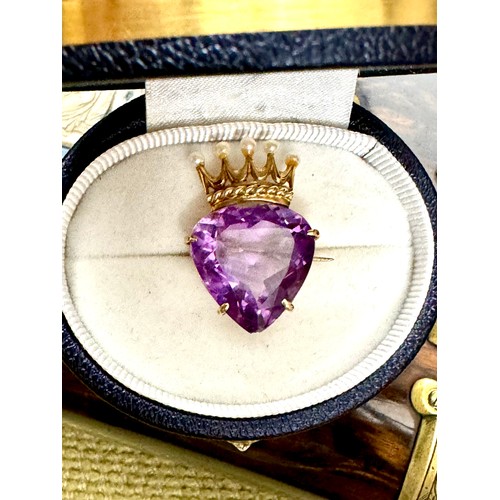 142 - A faceted heart shape amethyst brooch measuring approximately 18.8 mm x 18.8mm × 9.75mm. Set onto a ... 