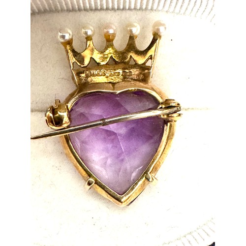 142 - A faceted heart shape amethyst brooch measuring approximately 18.8 mm x 18.8mm × 9.75mm. Set onto a ... 