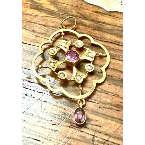 147 - An amethyst and half pearl pendant in an all yellow metal mount stamped '9ct'. A central round facet... 