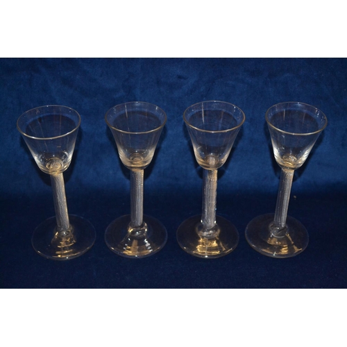66 - FOUR 18TH CENTURY MULTI SPIRAL AIR TWIST WINE GLASSES ON CIRCULAR FEET (15cm)