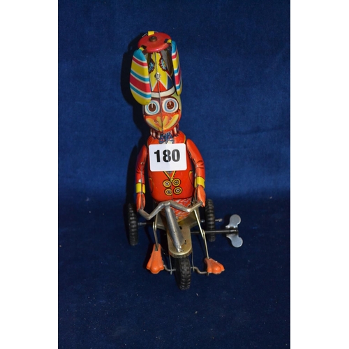 180 - TIN PLATE TOY OF DUCK SEATED ON PUSH ALONG TRICYCLE WITH 3 TWIRLING BLADES ABOVE, MADE IN CHINA