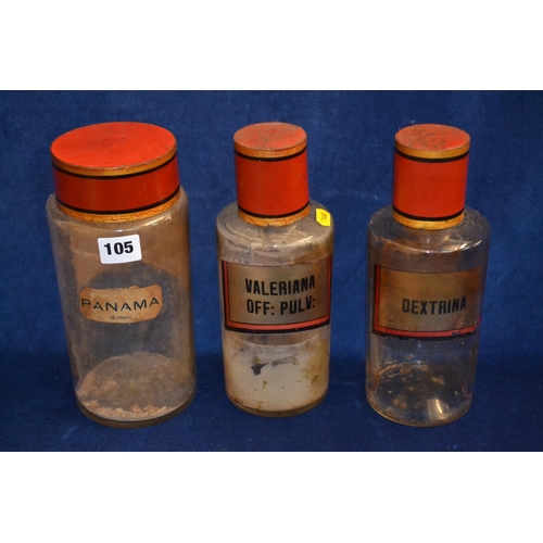 105 - THREE 19TH CENTURY GLASS DRUG JARS WITH TOLEWARE LIDS