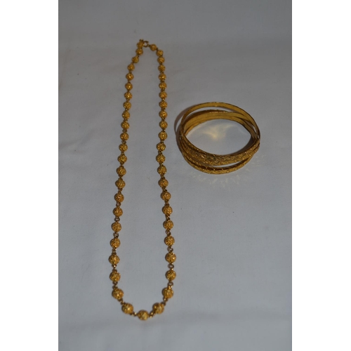 276 - 5 GILT METAL BANGLES AND NECKLACE