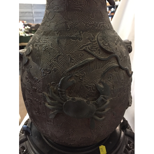 194 - PAIR OF 19TH CENTURY CHINESE BULBOUS LONG NECK BRONZE VASES WITH DRAGON AND SEALIFE RELIEF DECORATIO... 