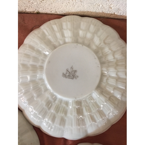 72 - THREE BELLEEK FINE PORCELAIN SHELL PATTERN TEACUPS AND SAUCERS WITH GILT RIMS AND BRANCH HANDLES